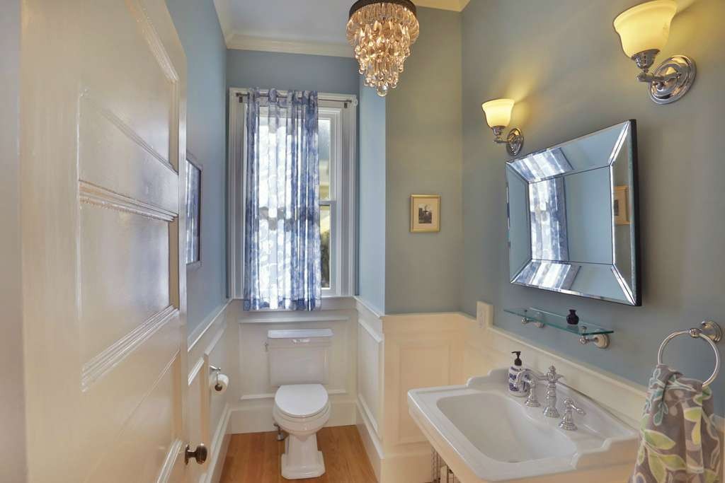 powder room with hardwood floors and pedestal sink