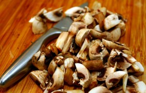 chopped mushrooms on cutting board - best housewarming gifts
