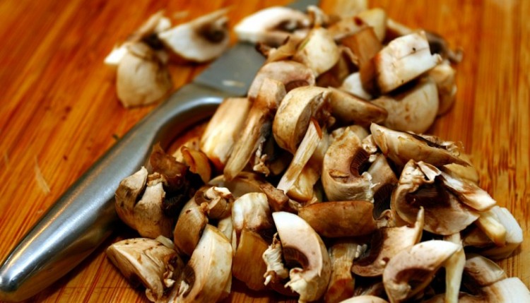 chopped mushrooms on cutting board - best housewarming gifts