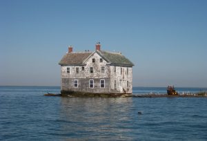 house swallowed by rising sea levels - flood insurance climate change global warming real estate