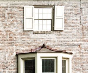 faded limewash on brick exterior