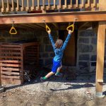 backyard monkey bars installed under deck