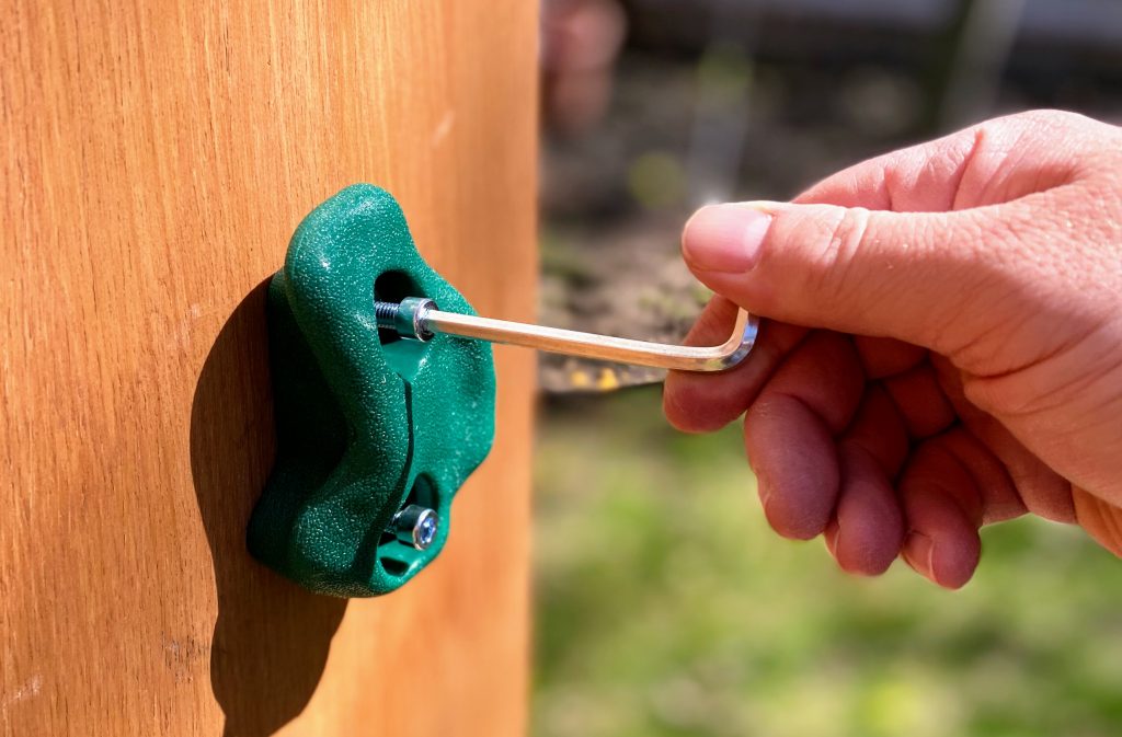 securing handholds to backyard climbing wall