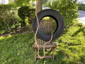 raising the tire swing on a chair will make it easier to tie a knot