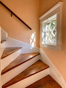 wood stairs and white risers after pulling up old carpet