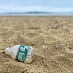 poland spring plastic water bottle on the beach - how to reduce plastic waste