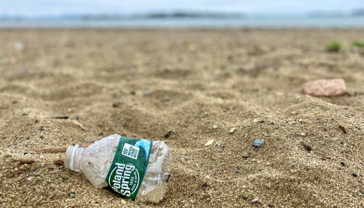 poland spring plastic water bottle on the beach - how to reduce plastic waste