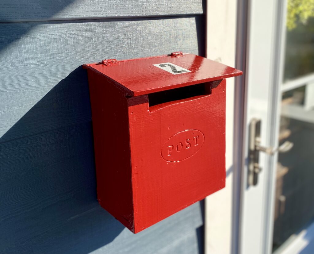 finished red letterbox painted and hung