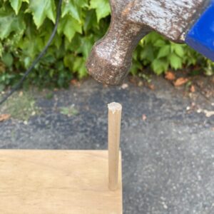 hammering a 3/8 inch wood dowel into the inset screw hole